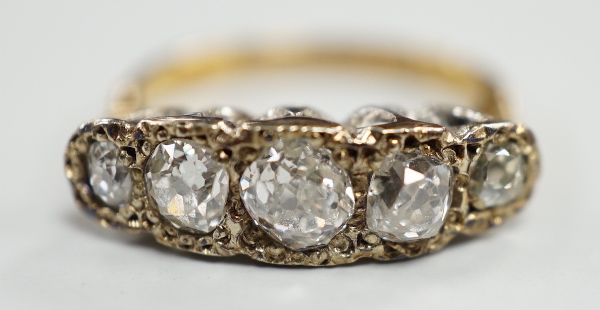 An 18ct, plat and graduated five stone diamond set half hoop ring, size J/K, gross weight 3.3 grams.